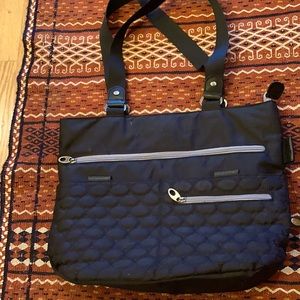 Black quilted tote bag with shoulder straps